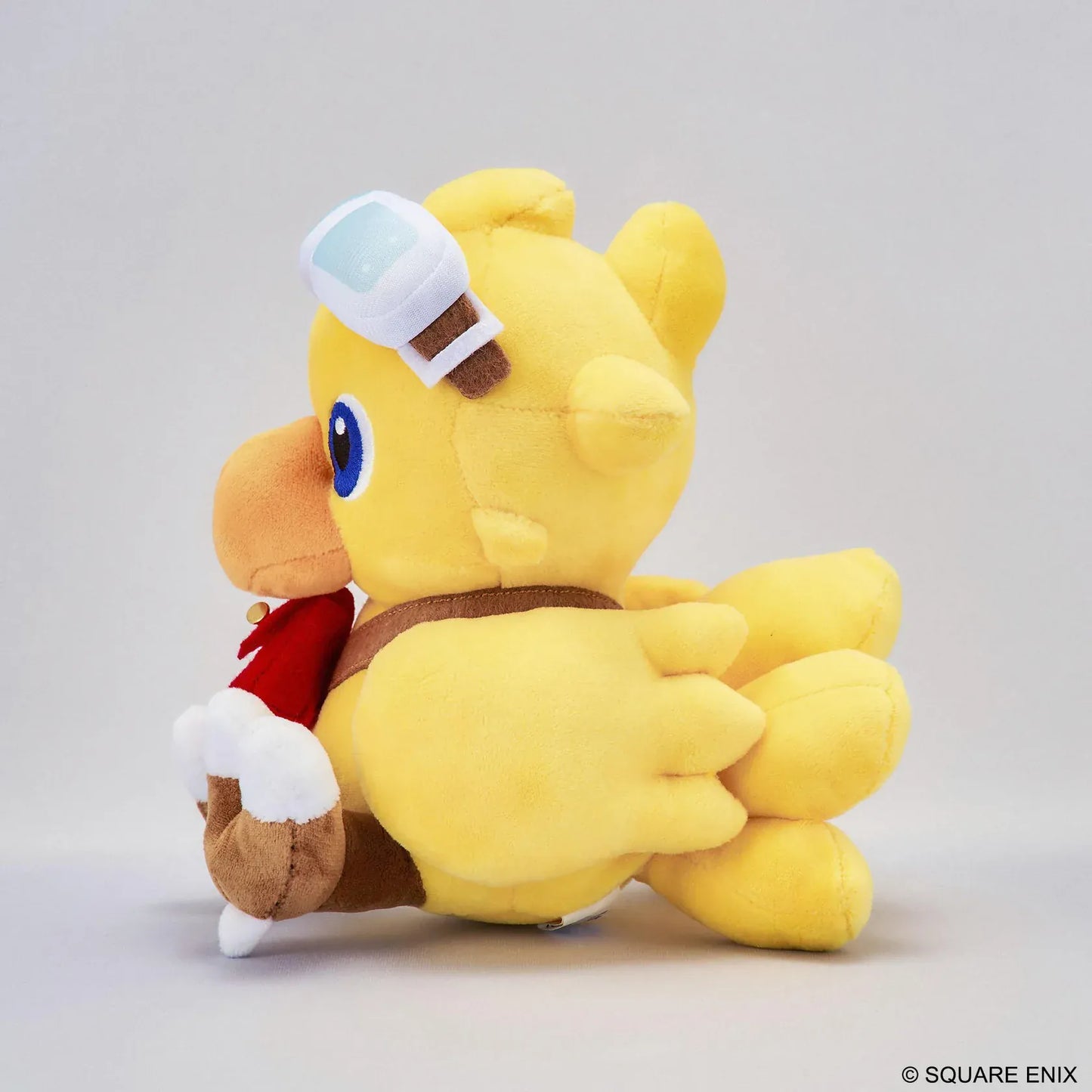 Final Fantasy Chocobo Chocobo and the Airship Ver. Plush with yellow Chocobo, pilot goggles, travel bag, blue embroidered eyes, and seated plush design