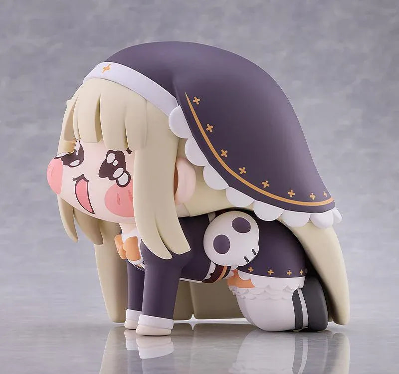 Petite Speaki soft vinyl figure with blonde hair, rosy cheeks, sparkling eyes, and a dark hood with gold accents.