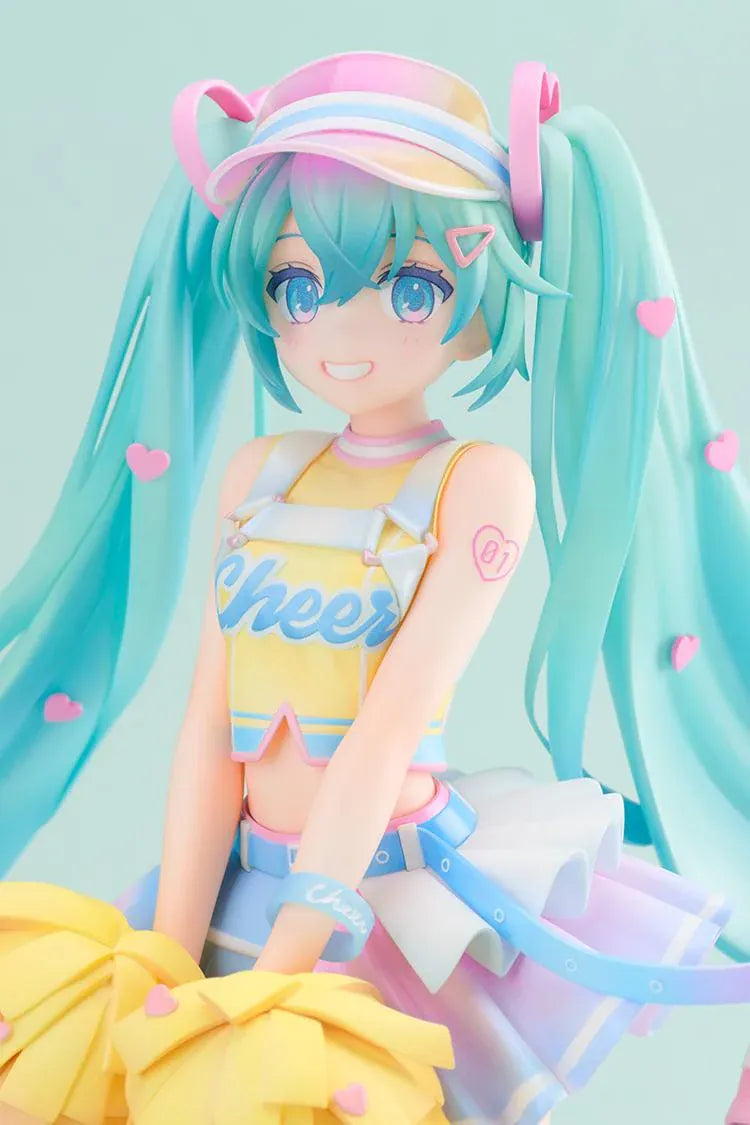Hatsune Miku Cheerleading Ver. 1/7 scale figure holding yellow pom-poms, with turquoise twin-tails, a pastel outfit, and one leg lifted.
