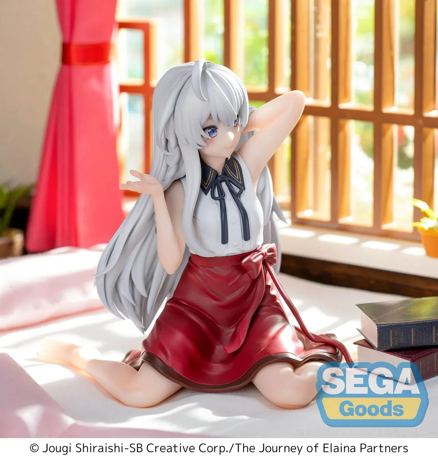 Figure of Elaina from Wandering Witch: The Journey of Elaina sitting on a bed in a white blouse and red skirt, with long silver hair and books beside her, in a sunlit room.
