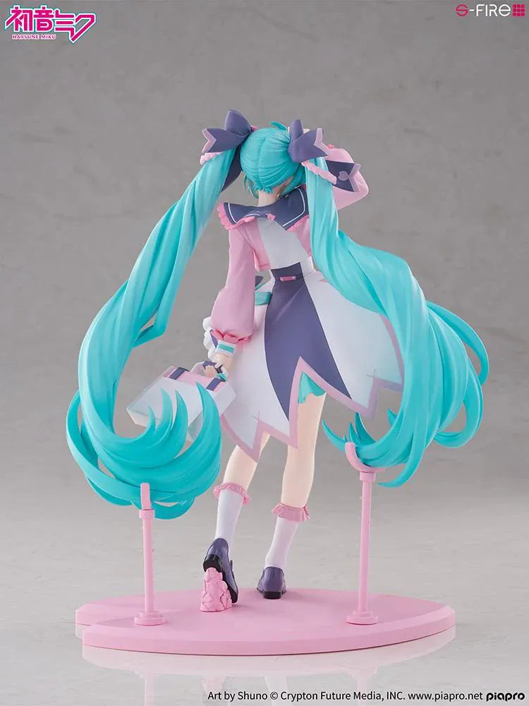Hatsune Miku New School Term figure with turquoise twin-tails, a pink and white ruffled outfit, purple bows, and flower accents on a pink base.