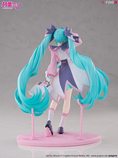 Hatsune Miku New School Term figure with turquoise twin-tails, a pink and white ruffled outfit, purple bows, and flower accents on a pink base.