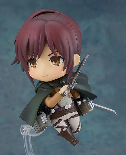 Attack on Titan Nendoroid Sasha Braus rerelease figure wearing her Survey Corps uniform and green cloak with dual blades and maneuvering gear.