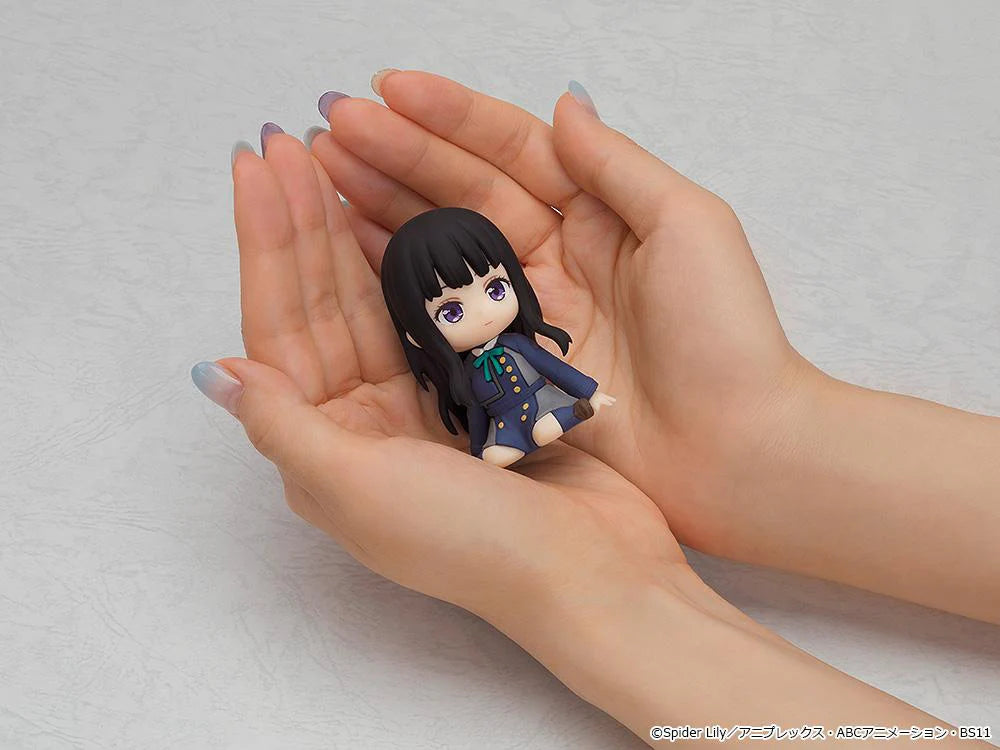 Lycoris Recoil Nendoroid Plus Takina Inoue Rubber Mascot Figure with black hair, dark uniform, green ribbon, and seated chibi pose