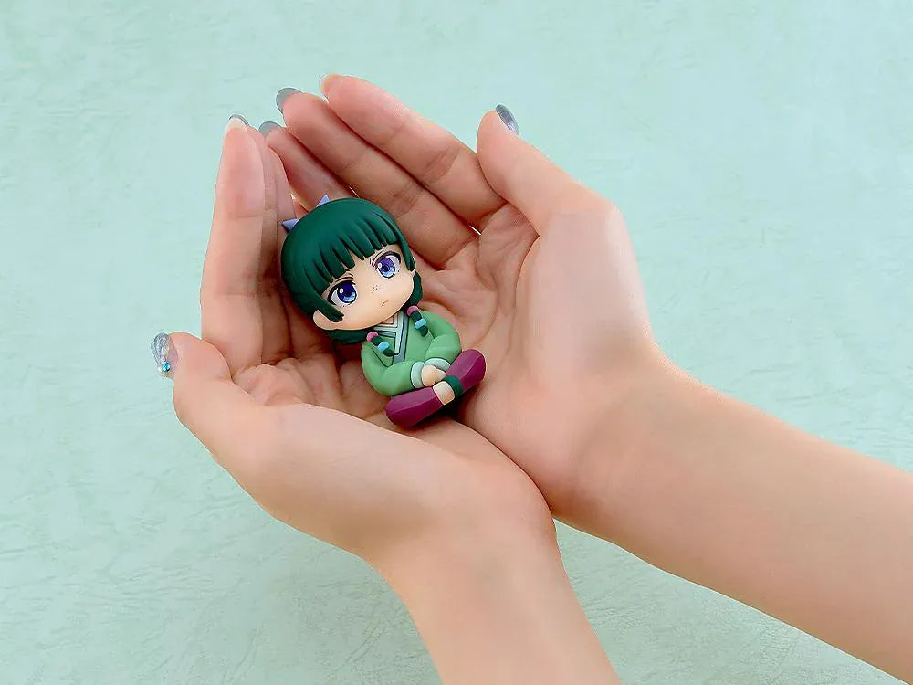 The Apothecary Diaries Nendoroid Plus Maomao rubber mascot seated in a green palace attendant outfit.