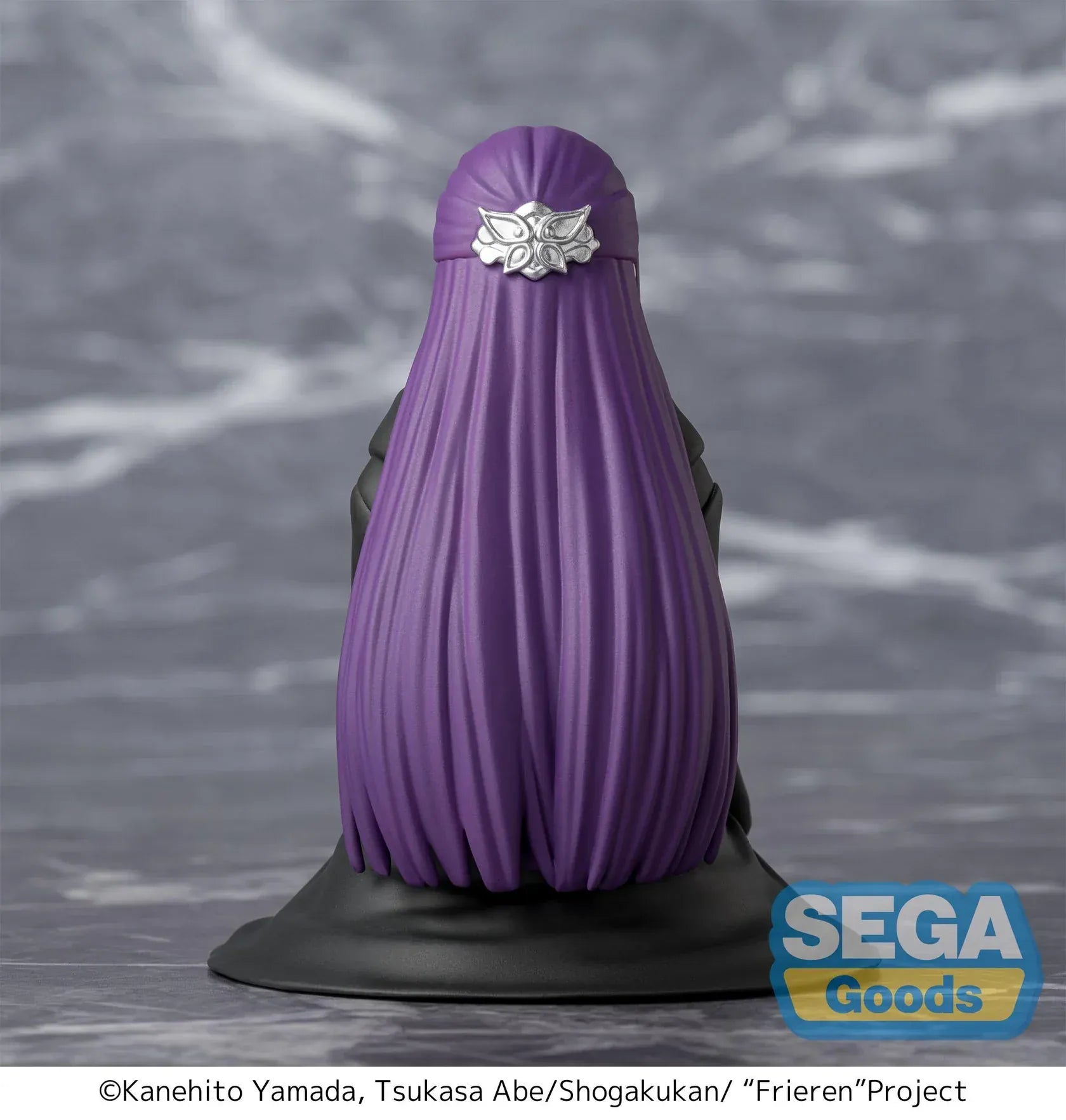 Perching figure of Fern from Frieren: Beyond Journey’s End kneeling calmly in robes, eyes closed in a binding spell pose, with long purple hair and a gray cloak.
