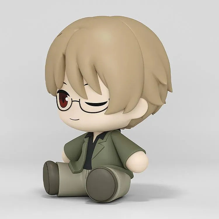 Shuichi Natori Huggy Good Smile figure seated in a green jacket and glasses with a playful winking expression.