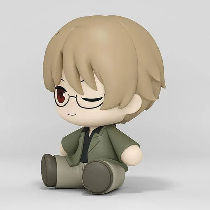 Shuichi Natori Huggy Good Smile figure seated in a green jacket and glasses with a playful winking expression.