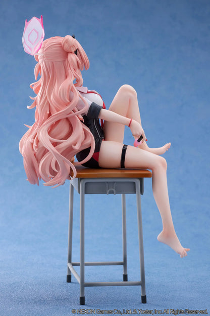 Blue Archive Kirara figure with long pink hair, black horns, and a pink halo, seated on a classroom desk beside nail polish bottles.