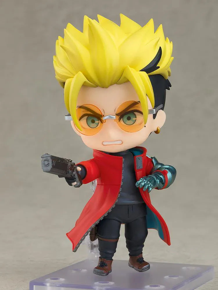 TRIGUN STARGAZE Vash the Stampede Nendoroid with spiky blond hair, orange glasses, a red coat, metallic teal mechanical arm, and raised handgun.