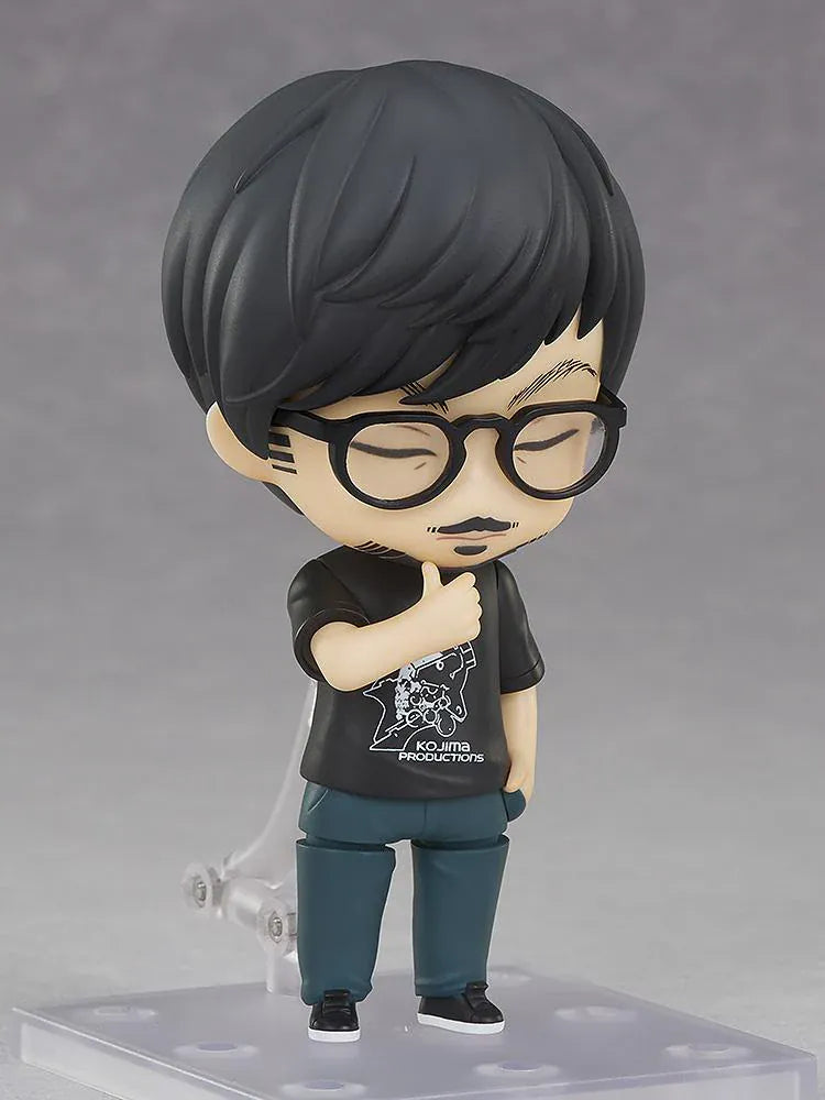 Kojima Productions Nendoroid Hideo Kojima Figure with glasses, black Kojima Productions shirt, and thumbs-up pose