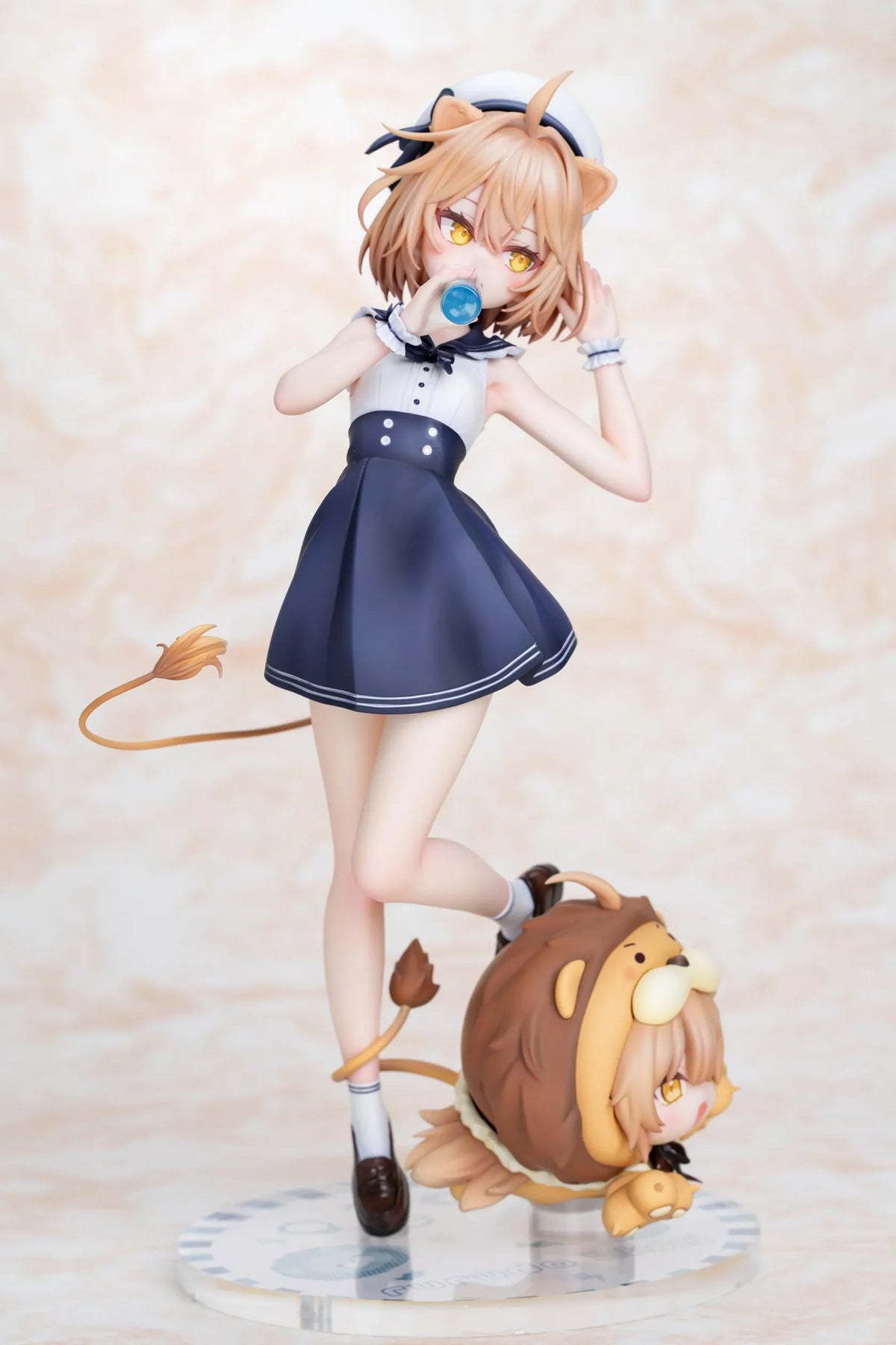 Rurudo Lion Marine Sailor Ver. figure in a navy and white sailor dress and hat, holding a blue bottle beside a chibi lion companion.