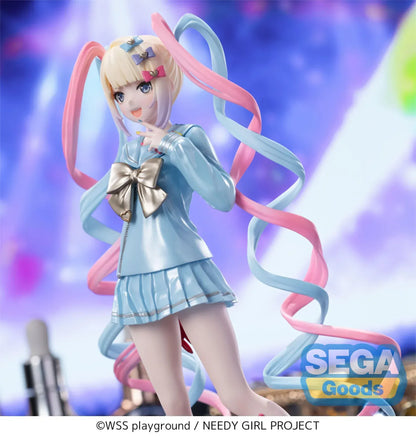 Luminasta OMGKawaiiAngel figure from Needy Streamer Overload standing on a clear base, wearing a pastel blue school outfit with gold bow and long pink-and-blue spiral twin tails, surrounded by makeup and accessories.