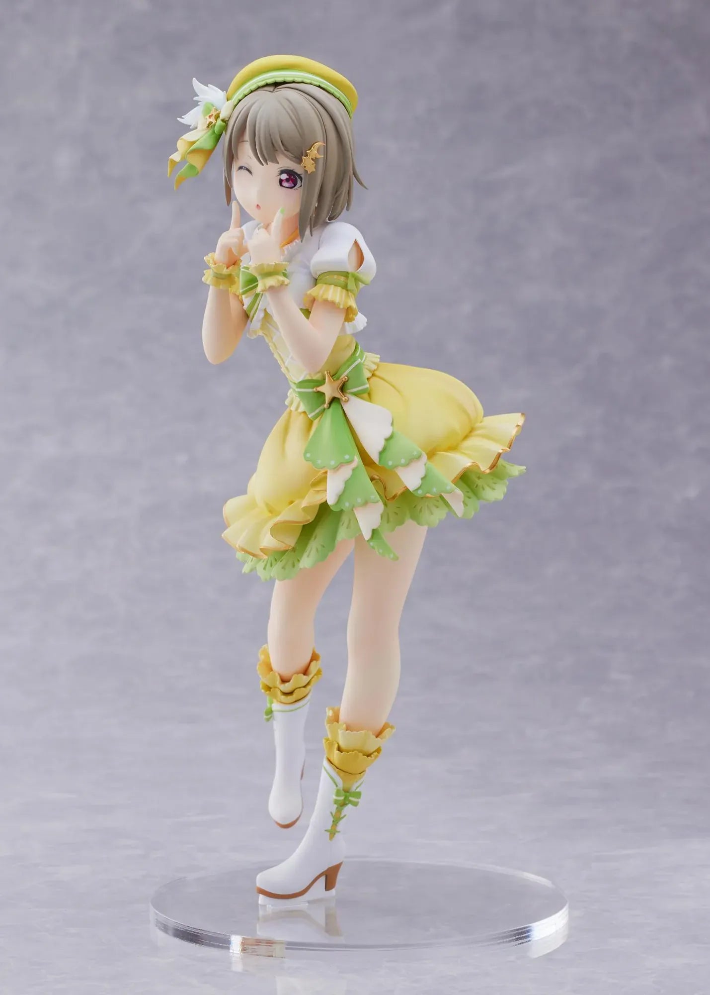 Love Live Nijigasaki High School Idol Club Kasumi Nakasu 1/7 Scale Figure featuring Kasumi in a yellow and green idol outfit with a winking expression, ribbon accents, and matching boots.