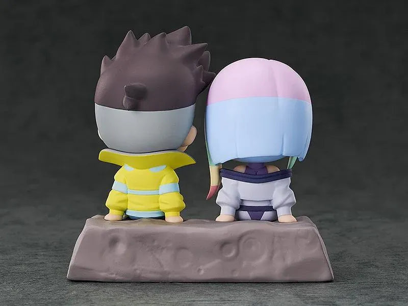 Cyberpunk: Edgerunners Qset+ David & Lucy To The Moon Figure (Rerelease) featuring chibi-style David Martinez with spiky black hair and a yellow jacket sitting beside Lucy Kushinada with pastel-colored hair and a purple futuristic outfit on a shared display base.