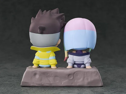 Cyberpunk: Edgerunners Qset+ David & Lucy To The Moon Figure (Rerelease) featuring chibi-style David Martinez with spiky black hair and a yellow jacket sitting beside Lucy Kushinada with pastel-colored hair and a purple futuristic outfit on a shared display base.