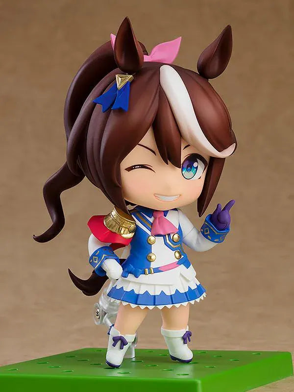 Umamusume Pretty Derby Nendoroid Tokai Teio rerelease figure with brown hair, a white forelock, pink bow, and blue-and-white racing uniform.