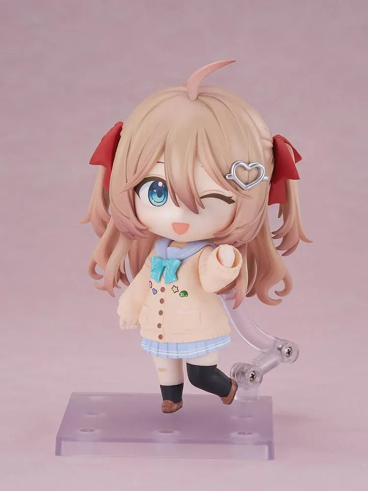 Neuro-sama Nendoroid figure with light brown hair, red ribbons, a heart hair clip, peach cardigan, turquoise bow, and a green turtle on her head.