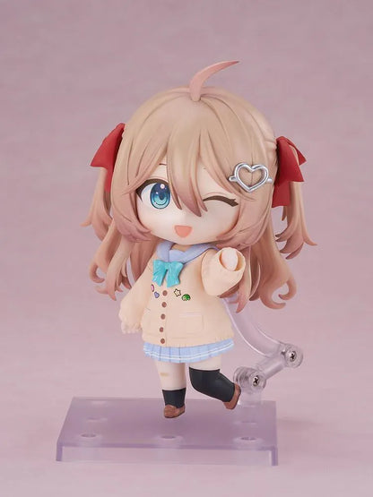 Neuro-sama Nendoroid figure with light brown hair, red ribbons, a heart hair clip, peach cardigan, turquoise bow, and a green turtle on her head.