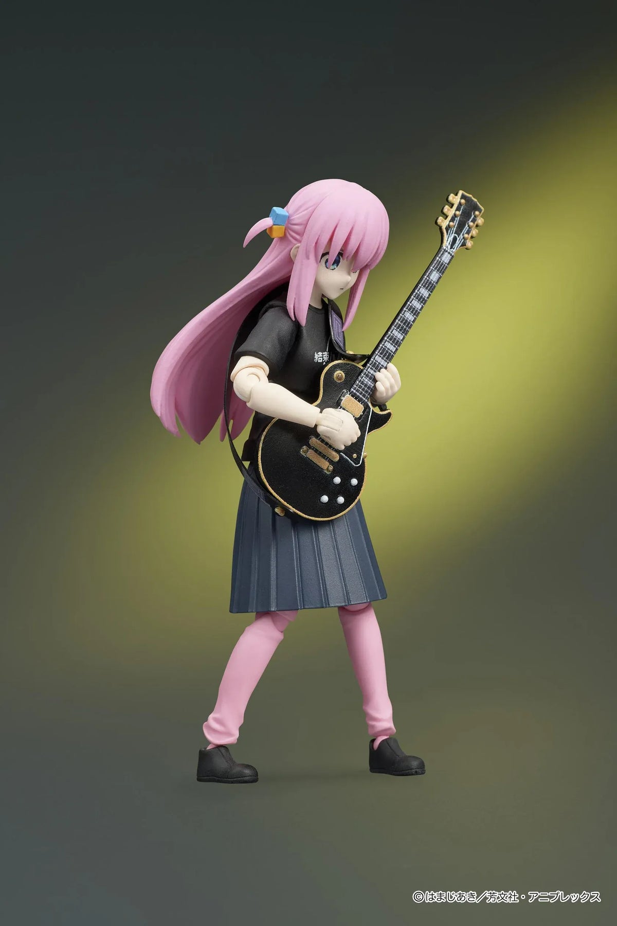 Bocchi the Rock! DIGACTION Hitori Gotoh figure holding a black and gold guitar, wearing a black band T-shirt, dark skirt, and pink leggings.