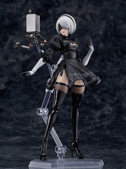 NieR Ver1.1a figma 2B figure with silver hair, a black visor, patterned black outfit, white sleeves, glossy boots, and a support robot.