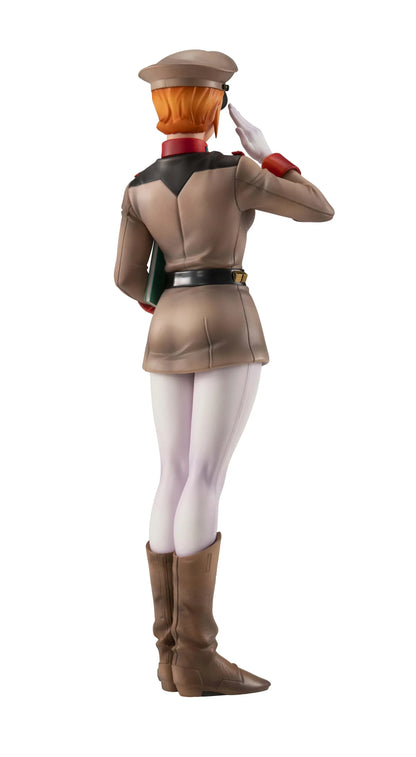 Gundam Girls Generation Matilda Ajan figure saluting in a tan military uniform and peaked cap, holding a green folder, with white trousers and brown boots.