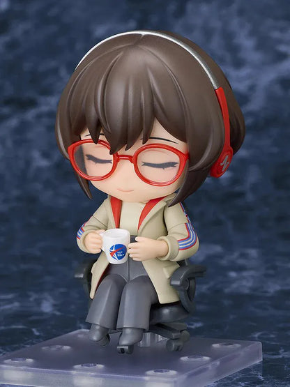 Nendoroid Satone figure seated in a black office chair, wearing red glasses, red headphones, a beige jacket, and dark gray trousers.