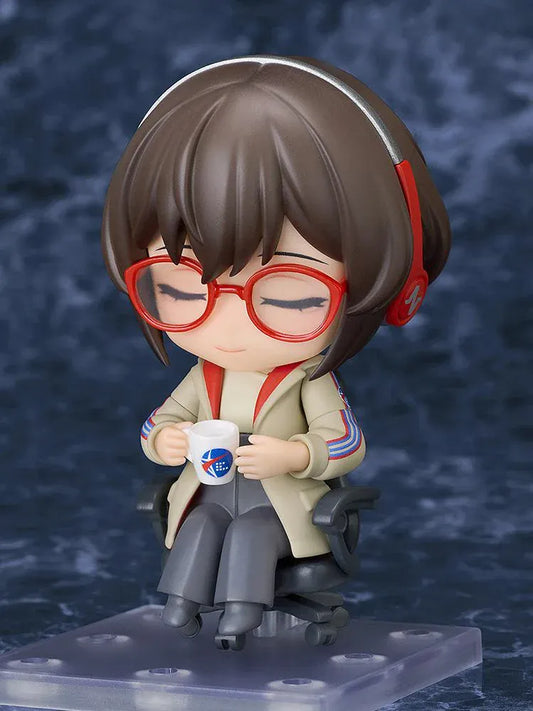 Nendoroid Satone figure seated in a black office chair, wearing red glasses, red headphones, a beige jacket, and dark gray trousers.