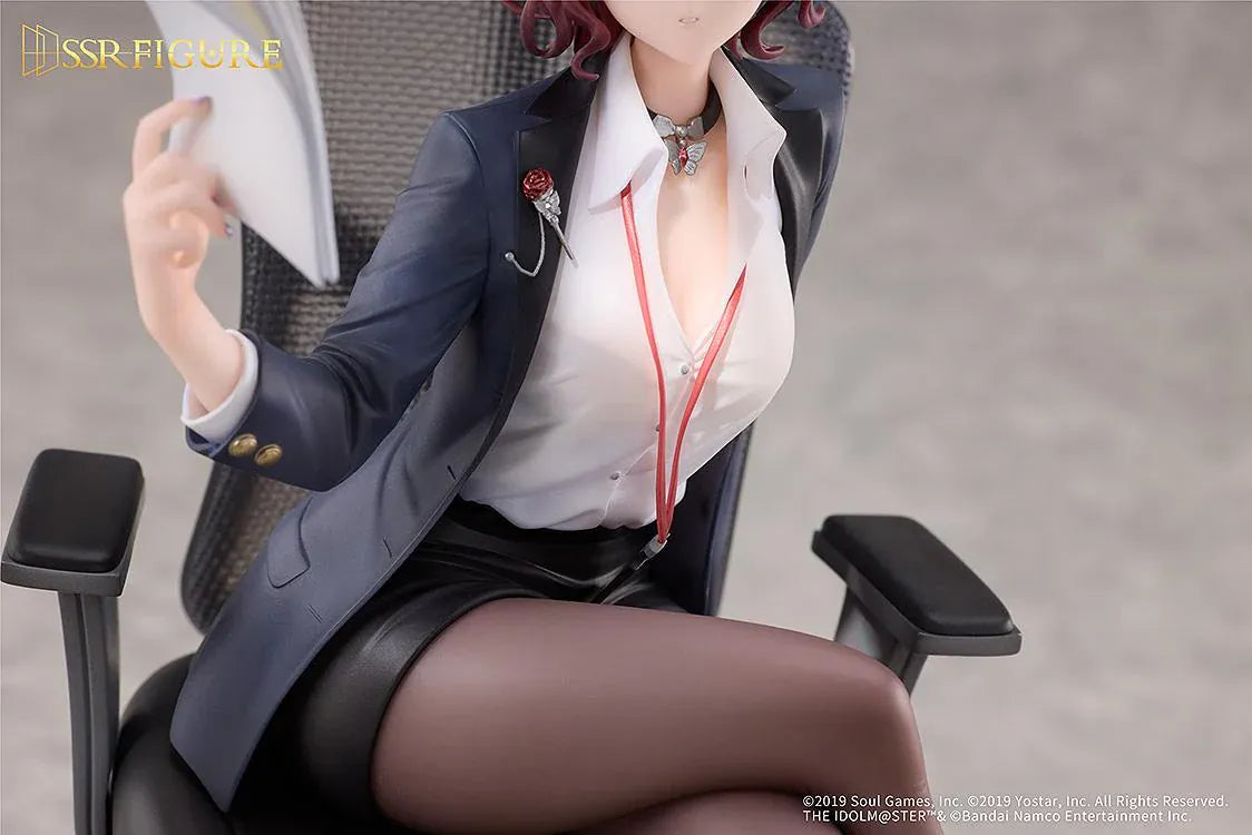 Madoka Higuchi Effortless Work Ver. figure seated in an office chair, wearing a navy blazer and holding papers above a clear circular base.