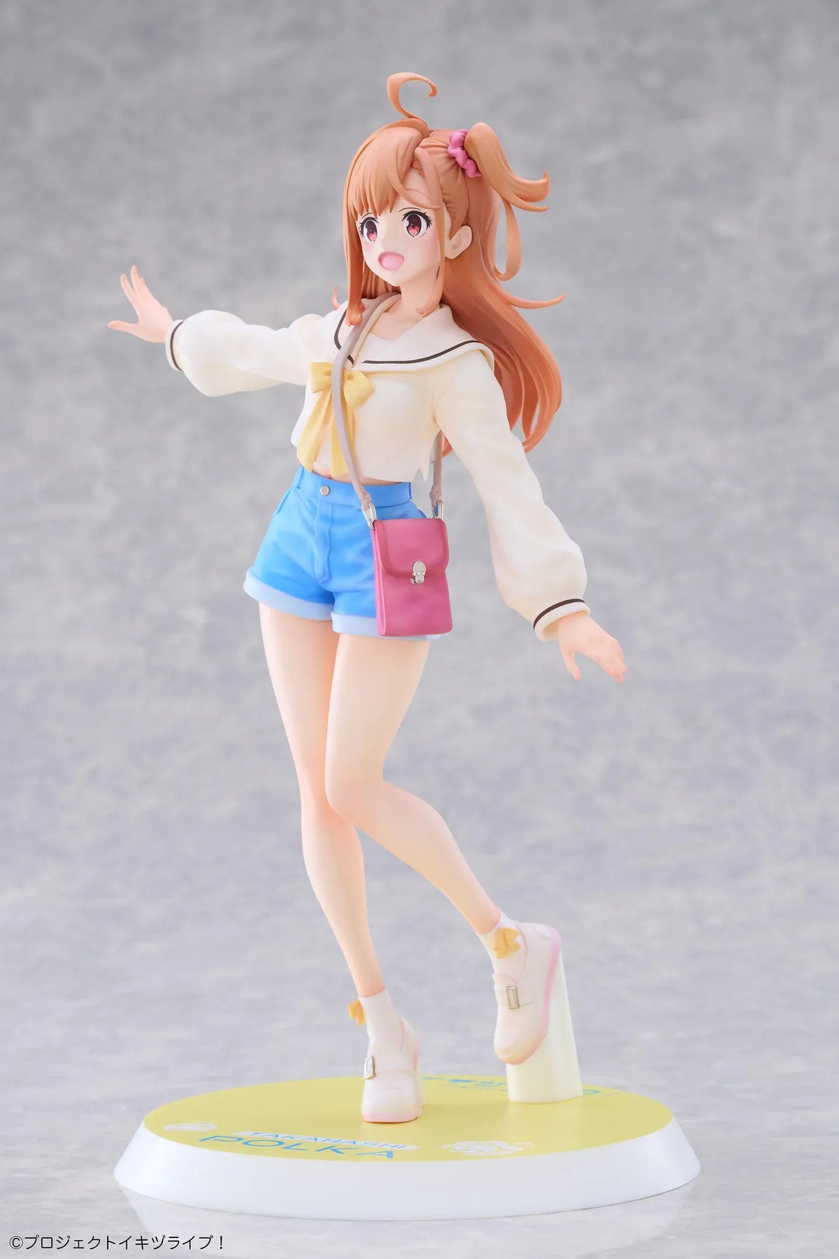 Polka Takahashi 1/7 scale figure with orange hair, a white sailor-style top, blue shorts, and a pink shoulder bag, posed on a yellow base.