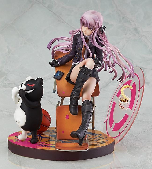 Kyoko Kirigiri 1/8 scale figure seated on a tilted classroom desk, with Monokuma, a basketball, and scattered furniture on a pink-accented base.