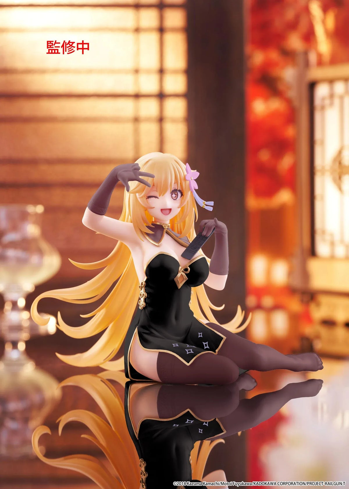 Desktop Cute Misaki Shokuho Chinese Dress Ver. figure seated in a black and gold dress, winking and holding a remote control, with flowing blonde hair