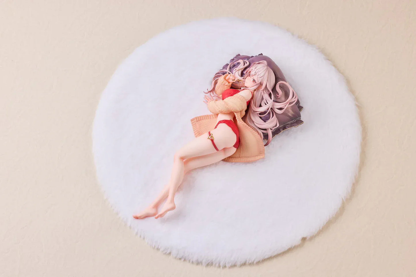 Makia 1/7 scale figure lying on a large fluffy white round base, wearing a cardigan and red lingerie, resting on a purple pillow
