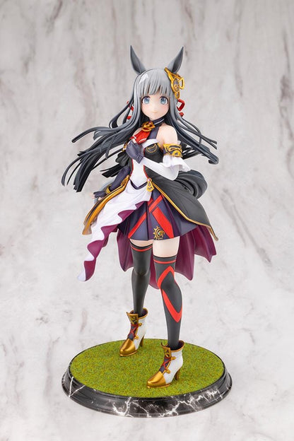 Umamusume Pretty Derby Chrono Genesis 1/7 Scale Figure featuring a silver-gray-haired horse girl with blue eyes, horse ears, and a flowing white, black, red, and gold racing outfit standing on a grassy display base.