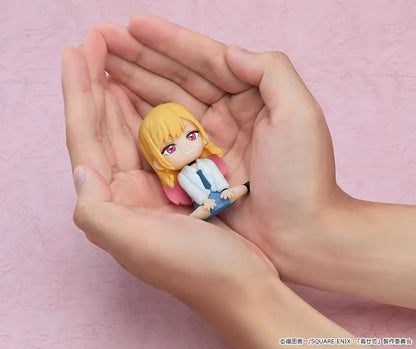 My Dress-Up Darling Nendoroid Plus Marin Kitagawa rubber mascot figure with blonde and pink hair, a white shirt, blue tie, and plaid skirt.