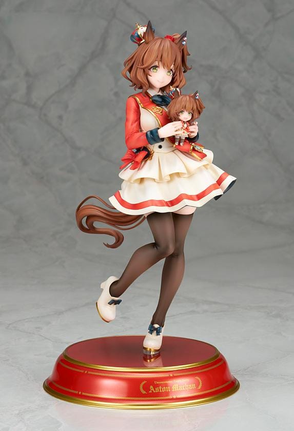 UmaMusume Pretty Derby Aston Machan 1/7 Scale Figure featuring Aston Machan with horse ears, short brown hair, red-and-cream outfit, plush doll accessory, and themed display base.