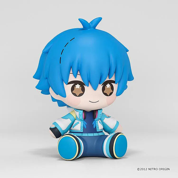 DRAMAtical Murder Huggy Good Smile Aoba figure with blue hair, star-filled eyes, headphones, and a blue-and-white outfit in a seated pose.