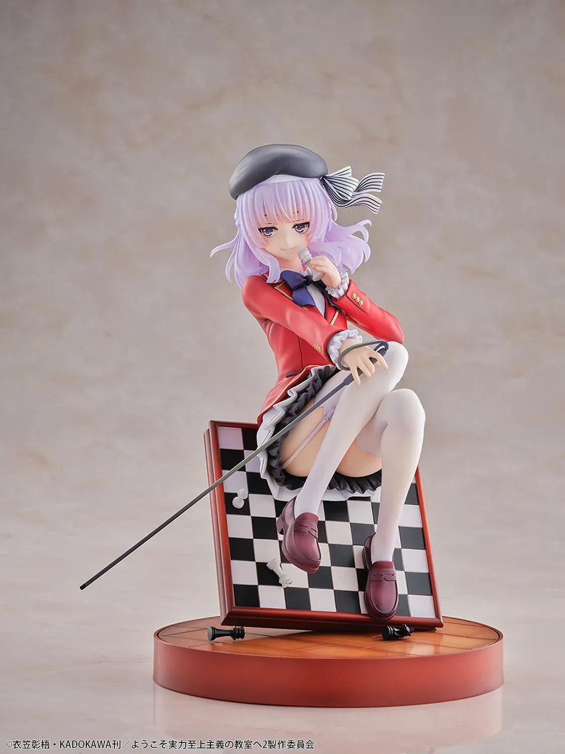 Arisu Sakayanagi 1/7 scale figure in a red uniform and black beret, holding a chess piece with her cane across a tilted chessboard display.