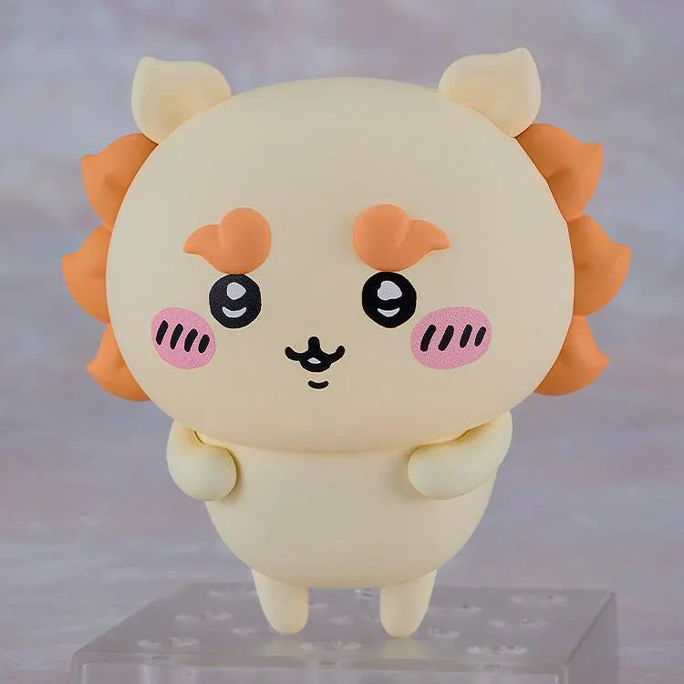 Chiikawa Nendoroid Shisa figure with a cream-colored body, orange mane and eyebrows, pink cheeks, and a joyful smiling expression.