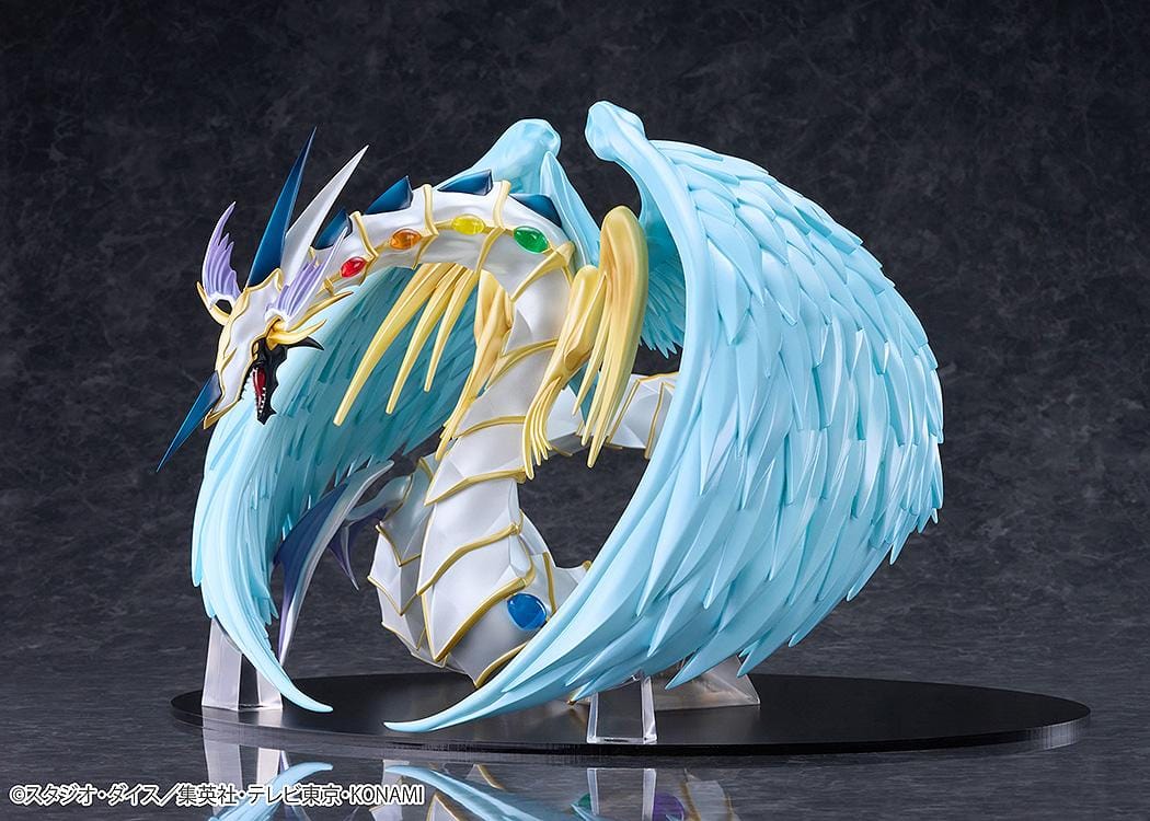 Yu-Gi-Oh! GX Rainbow Dragon figure with a pearlescent armored body, multicolored crystals, gold accents, and translucent blue wings.