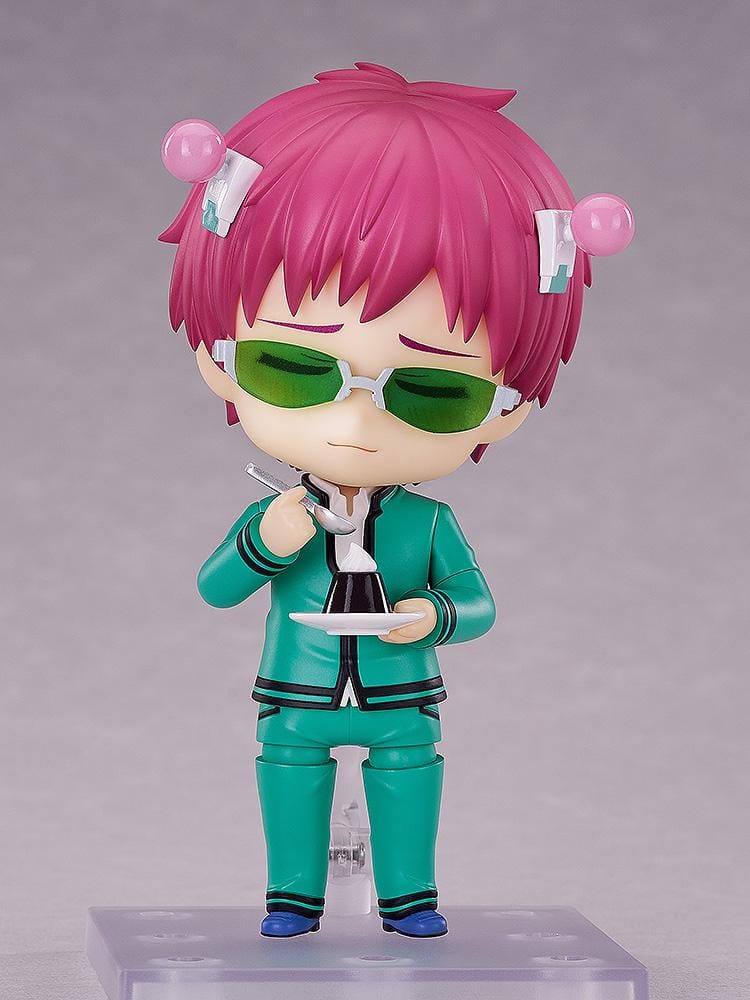 Kusuo Saiki Nendoroid with pink hair, pink-tipped head accessories, green glasses, and a teal school uniform, posed with one hand extended.