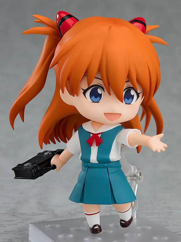 Rebuild of Evangelion Nendoroid Asuka Shikinami Langley Figure Rerelease featuring Asuka with orange twin tails, blue eyes, school uniform, and cheerful waving pose.