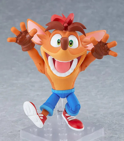 Crash Bandicoot Nendoroid rerelease figure with orange fur, a large grin, blue shorts, and red sneakers in an energetic pose.