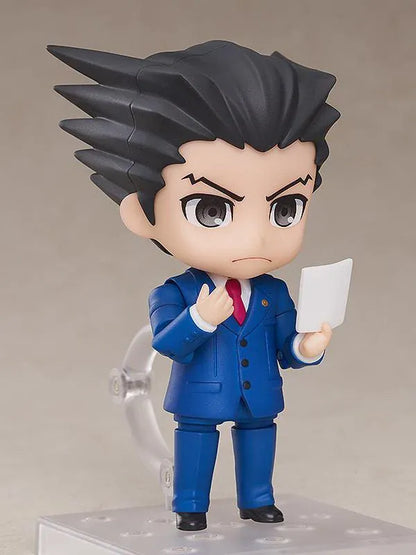 Ace Attorney Phoenix Wright Nendoroid rerelease figure wearing a blue suit and pointing beside a Japanese Objection effect part.