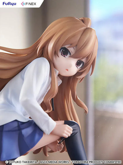 1/7 scale Toradora figure of Taiga Aisaka at home, barefoot and leaning on a leather armchair while pulling on a black thigh-high sock, wearing her school shirt and blue skirt.