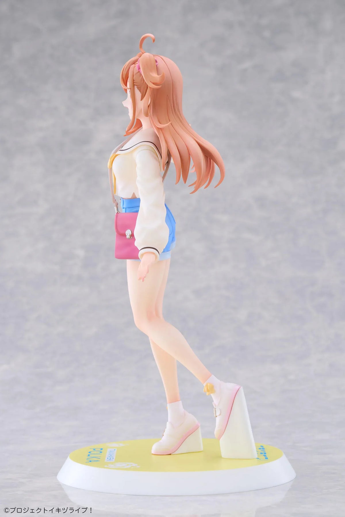 Polka Takahashi 1/7 scale figure with orange hair, a white sailor-style top, blue shorts, and a pink shoulder bag, posed on a yellow base.