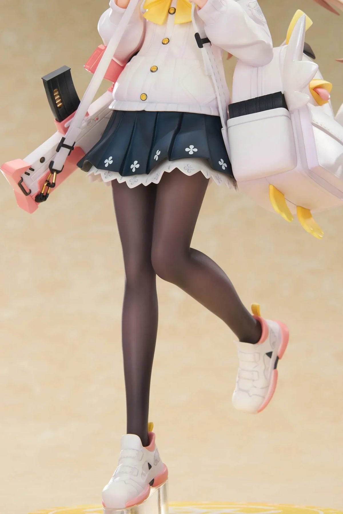 Blue Archive Hifumi figure smiling with one foot lifted, wearing a white cardigan and navy skirt, carrying a bird-themed bag and rifle on a yellow base.