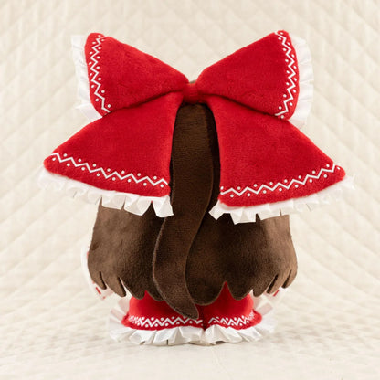 Touhou Project Chai Chara Project Reimu Hakurei Plushie featuring brown hair, embroidered brown eyes, an oversized red hair bow, a red and white shrine maiden outfit, and a cute seated chibi design.