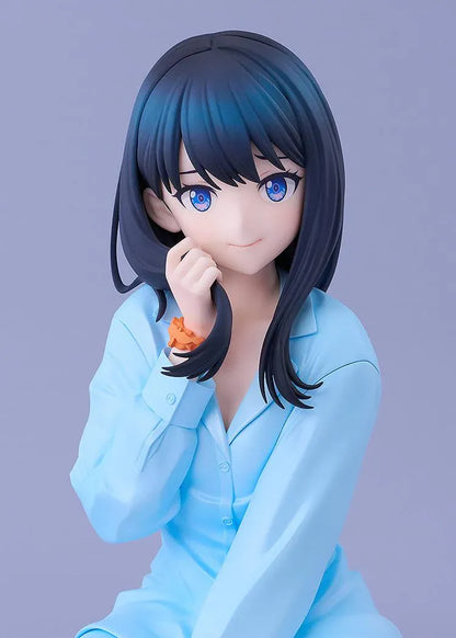 GRIDMAN UNIVERSE Rikka Takarada Pajamas Ver. figure seated in light blue pajamas, with dark hair, blue eyes, and an orange wrist scrunchie.