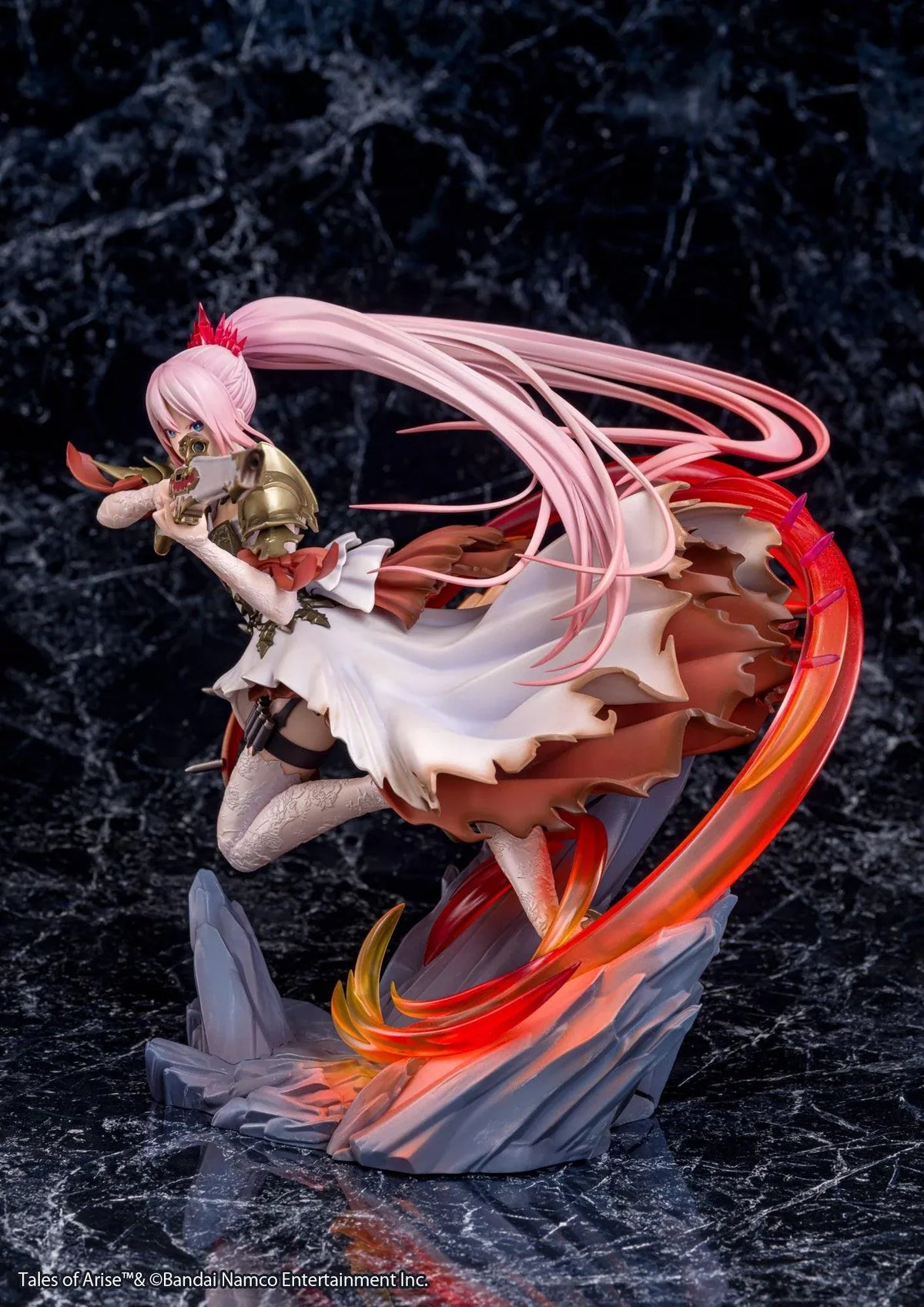 Tales of Arise Shionne 1/7 Scale Figure featuring a pink-haired anime character with blue eyes, an ornate white battle dress, gold armor, and lace stockings, aiming a detailed rifle while suspended in a dynamic pose surrounded by translucent red and orange effects on a rocky display base.